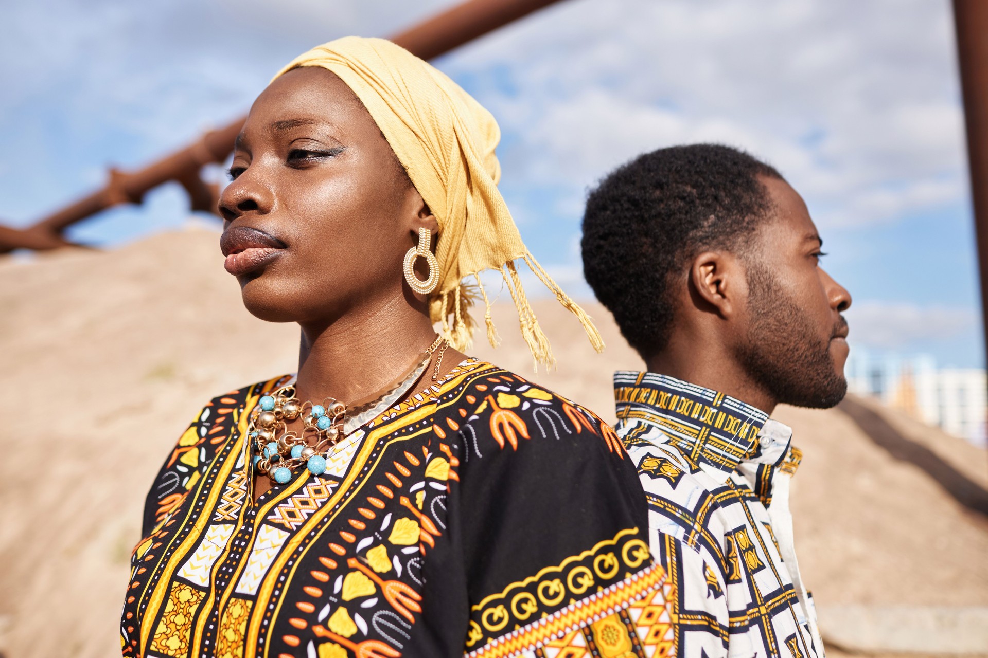 Traditional African American Couple Standing Back To Back in Desert Sun